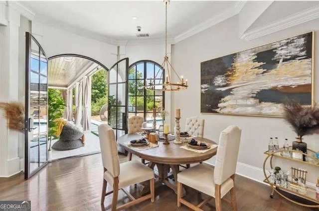 2242 Shoal Creek Rd, Buford, GA 30518 - dining area with healthy amount of natural light, ornamental molding, wood finished floors, and a chandelier
