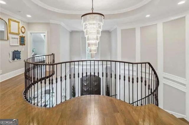 2242 Shoal Creek Rd, Buford, GA 30518 - staircase featuring a chandelier, crown molding, recessed lighting, wood finished floors, and a raised ceiling