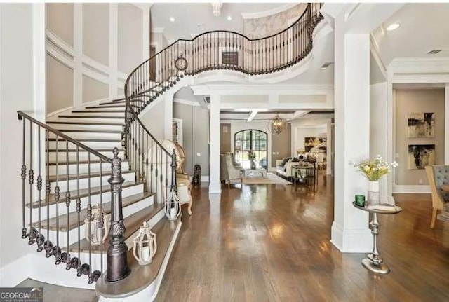 2242 Shoal Creek Rd, Buford, GA 30518 - foyer with crown molding, wood finished floors, stairway, a chandelier, and baseboards