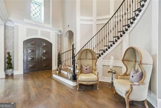 2242 Shoal Creek Rd, Buford, GA 30518 - entryway with a high ceiling, stairs, arched walkways, and wood finished floors