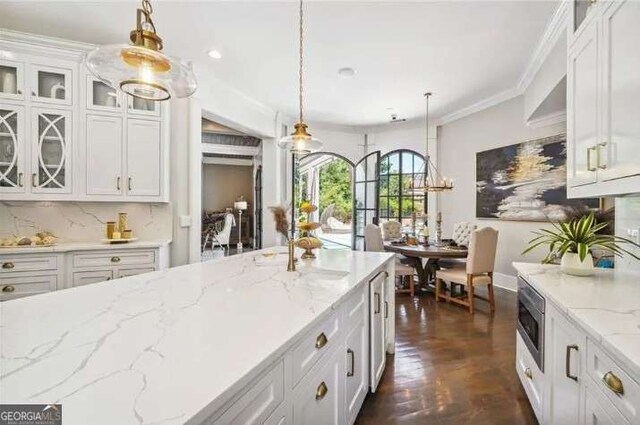 2242 Shoal Creek Rd, Buford, GA 30518 - kitchen with white cabinets, pendant lighting, glass insert cabinets, light stone counters, and recessed lighting