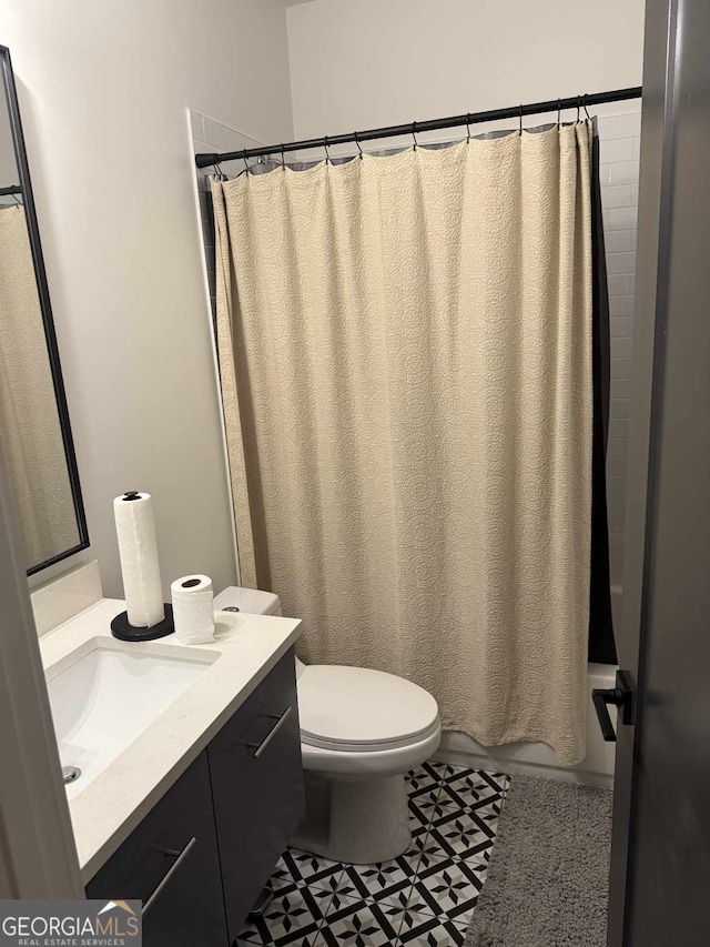 bathroom with vanity, toilet, and shower / bath combo with shower curtain