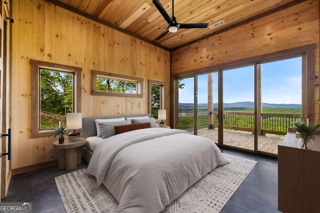 885 Tower Rd, Mineral Bluff, GA 30559 - bedroom featuring wooden walls, access to exterior, a mountain view, wood ceiling, and concrete flooring