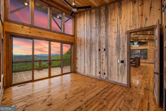 885 Tower Rd, Mineral Bluff, GA 30559 - spare room with high vaulted ceiling, wood walls, wood-type flooring, a mountain view, and ceiling fan