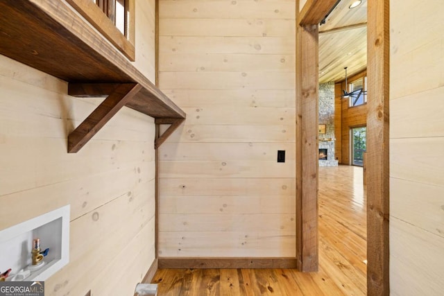 885 Tower Rd, Mineral Bluff, GA 30559 - clothes washing area with wooden walls, hardwood / wood-style flooring, hookup for a washing machine, and an outdoor stone fireplace