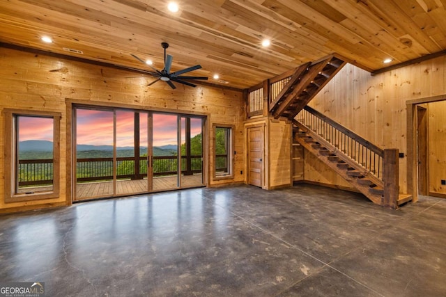 885 Tower Rd, Mineral Bluff, GA 30559 - unfurnished living room featuring wooden walls, stairway, a ceiling fan, concrete floors, and recessed lighting