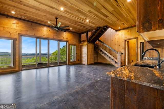 885 Tower Rd, Mineral Bluff, GA 30559 - unfurnished living room featuring concrete floors, wood walls, wood ceiling, stairs, and recessed lighting