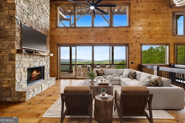 885 Tower Rd, Mineral Bluff, GA 30559 - living area with a high ceiling, wood-type flooring, wood walls, and a fireplace