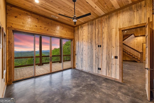 885 Tower Rd, Mineral Bluff, GA 30559 - unfurnished room featuring wood walls, a ceiling fan, concrete flooring, plenty of natural light, and wood ceiling