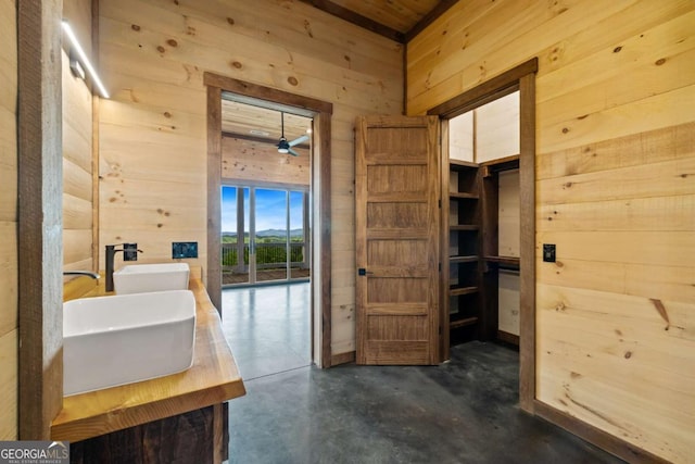 885 Tower Rd, Mineral Bluff, GA 30559 - bathroom featuring wooden walls, a sink, and concrete floors