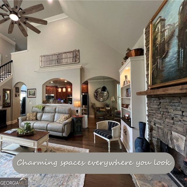 24 Douglas Dr, Jefferson, GA 30549 - living area with arched walkways, ceiling fan, dark wood-type flooring, high vaulted ceiling, and crown molding