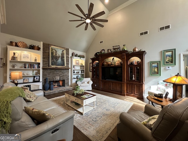 24 Douglas Dr, Jefferson, GA 30549 - living area with high vaulted ceiling, ceiling fan, dark wood-type flooring, and a stone fireplace