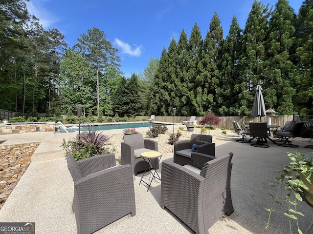 24 Douglas Dr, Jefferson, GA 30549 - fenced backyard with a patio, outdoor dining area, and view of wooded area