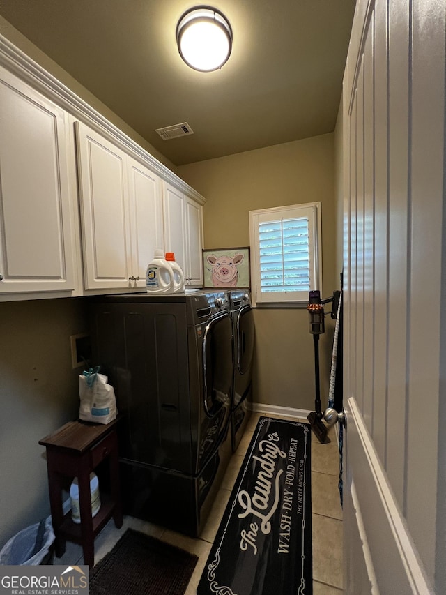 24 Douglas Dr, Jefferson, GA 30549 - laundry room with washer and clothes dryer, cabinet space, and light tile patterned flooring