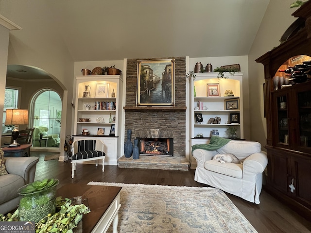 24 Douglas Dr, Jefferson, GA 30549 - living room with lofted ceiling, arched walkways, dark wood finished floors, and a fireplace