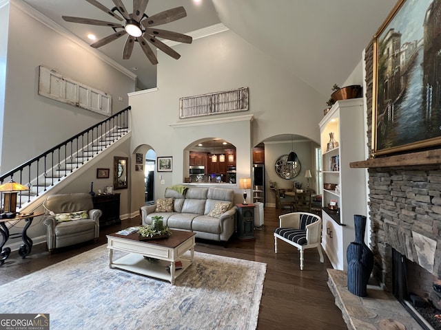 24 Douglas Dr, Jefferson, GA 30549 - living area featuring ceiling fan, stairway, a stone fireplace, dark wood-style floors, and arched walkways