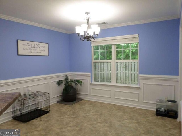 124 Fontenot Dr, Savannah, GA 31405 - dining room with a chandelier, wainscoting, ornamental molding, and a decorative wall