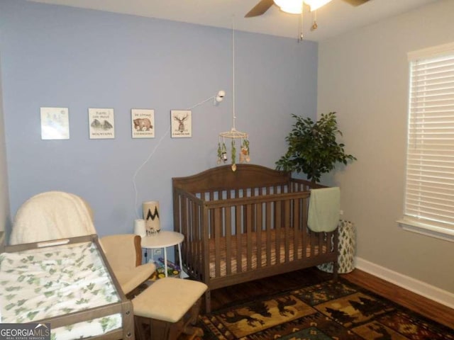 124 Fontenot Dr, Savannah, GA 31405 - bedroom with wood finished floors, baseboards, a crib, and ceiling fan