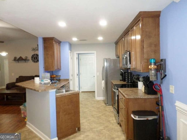 124 Fontenot Dr, Savannah, GA 31405 - kitchen featuring stainless steel appliances, brown cabinetry, a peninsula, baseboards, and recessed lighting