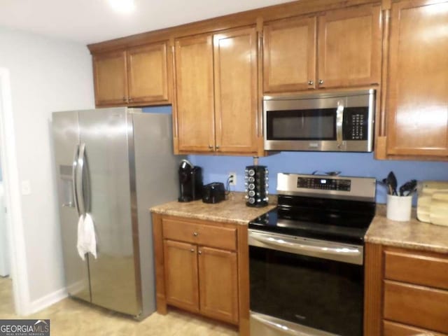 124 Fontenot Dr, Savannah, GA 31405 - kitchen featuring stainless steel appliances, brown cabinets, and baseboards
