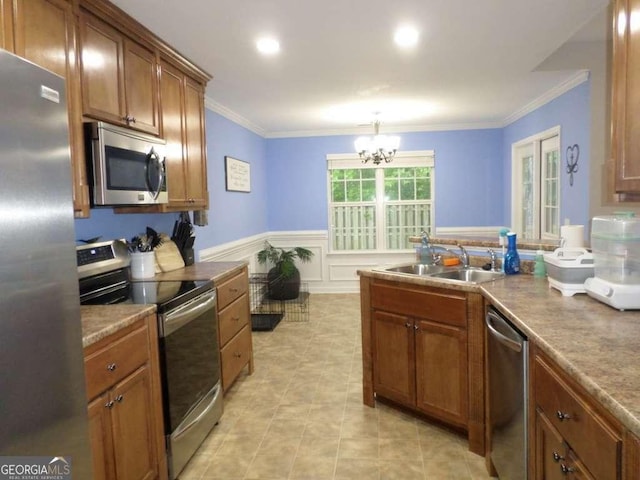 124 Fontenot Dr, Savannah, GA 31405 - kitchen featuring appliances with stainless steel finishes, a sink, crown molding, brown cabinets, and a chandelier