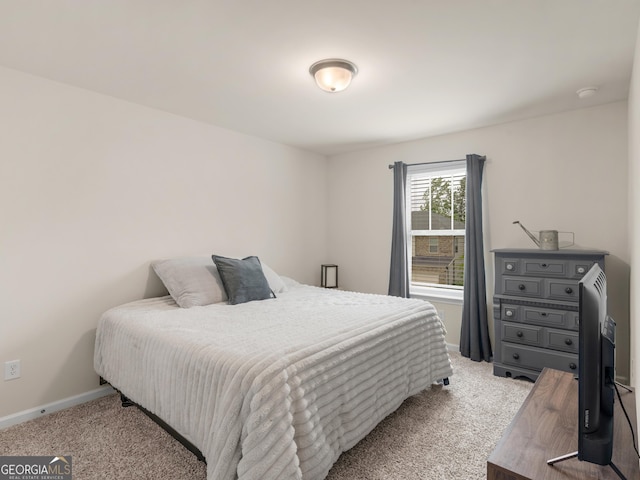 carpeted bedroom with baseboards