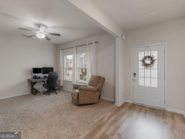 home office featuring a ceiling fan, wood finished floors, and baseboards