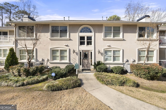1538 Chantilly Dr NE Unit 224, Atlanta, GA 30324 - view of property with a chimney, stucco siding, and central AC unit