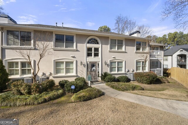 1538 Chantilly Dr NE Unit 224, Atlanta, GA 30324 - townhome / multi-family property with a chimney, central air condition unit, and stucco siding