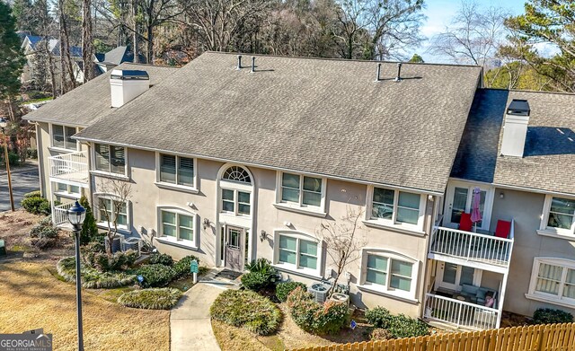 1538 Chantilly Dr NE Unit 224, Atlanta, GA 30324 - view of front of home featuring a chimney, roof with shingles, and stucco siding