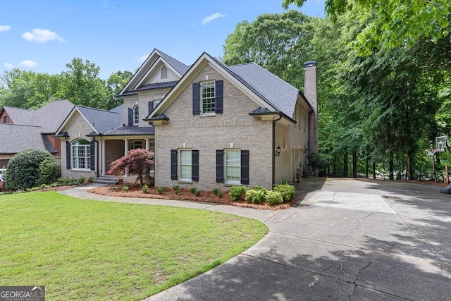 2332 Autumn Maple Dr, Braselton, GA 30517 - view of front of property featuring concrete driveway, brick siding, a front yard, a chimney, and roof with shingles