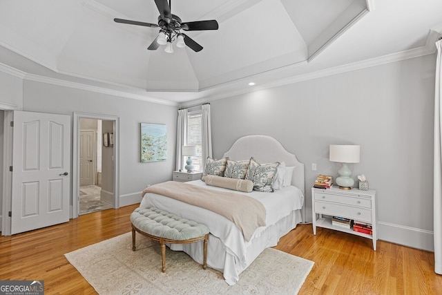 2332 Autumn Maple Dr, Braselton, GA 30517 - bedroom featuring a raised ceiling, light wood-type flooring, crown molding, ceiling fan, and ensuite bath