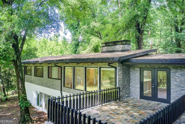 rear view of house featuring french doors