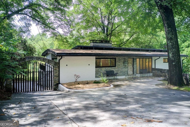 mid-century home featuring stone siding