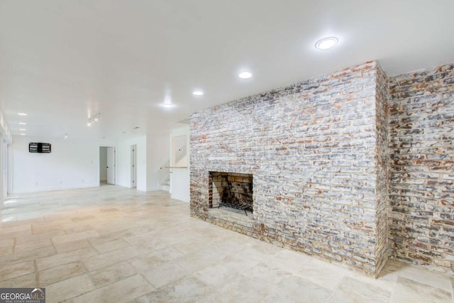 unfurnished living room with a fireplace and recessed lighting