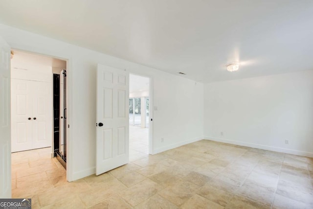 spare room featuring baseboards