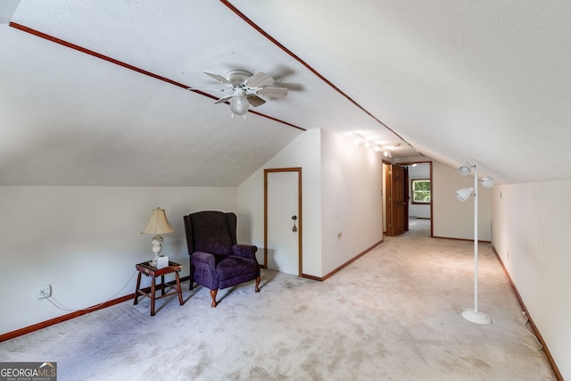 sitting room with lofted ceiling, a ceiling fan, carpet flooring, and baseboards