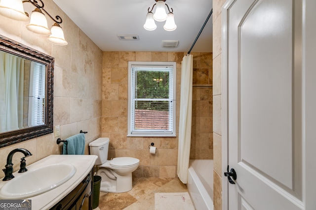 full bathroom with tile walls, toilet, and vanity