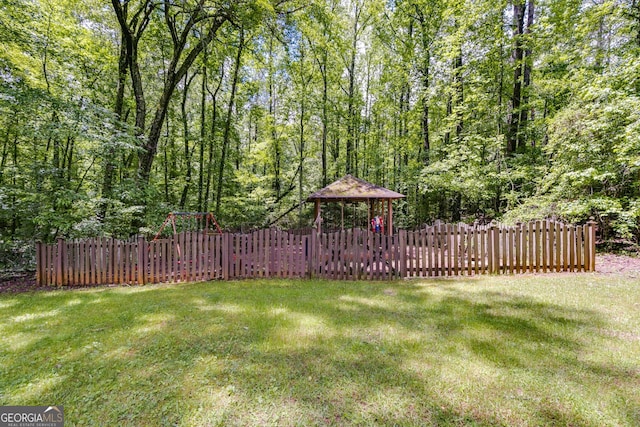view of yard featuring a gazebo and a view of trees
