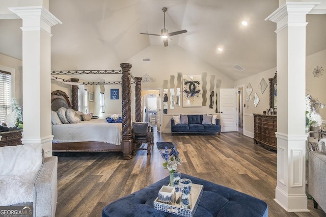 bedroom with decorative columns, multiple windows, high vaulted ceiling, and wood finished floors