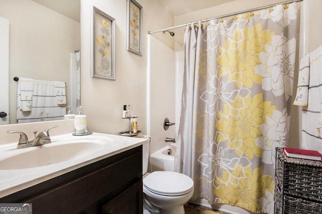 bathroom with vanity, shower / bath combo, and toilet