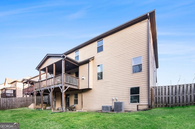 rear view of house with central AC and a deck