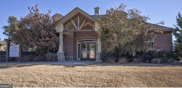 view of front of property with french doors and brick siding