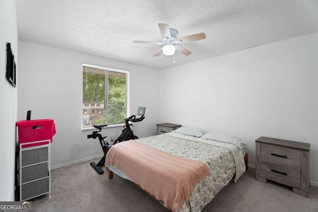 bedroom featuring carpet flooring, a textured ceiling, baseboards, and a ceiling fan