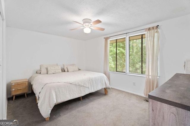 carpeted bedroom featuring a ceiling fan and baseboards