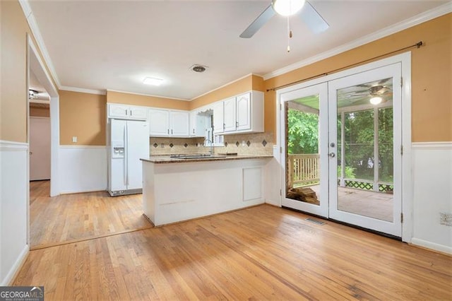 890 Oriole Ln, Marietta, GA 30067 - kitchen with white fridge with ice dispenser, a ceiling fan, white cabinets, a peninsula, and light wood-type flooring