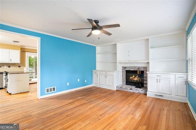 890 Oriole Ln, Marietta, GA 30067 - unfurnished living room with a ceiling fan, baseboards, light wood-type flooring, a fireplace, and crown molding