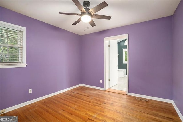 890 Oriole Ln, Marietta, GA 30067 - spare room featuring plenty of natural light, baseboards, ceiling fan, and light wood-type flooring