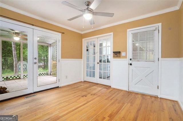 890 Oriole Ln, Marietta, GA 30067 - entryway with french doors, ceiling fan, light wood finished floors, a wainscoted wall, and crown molding
