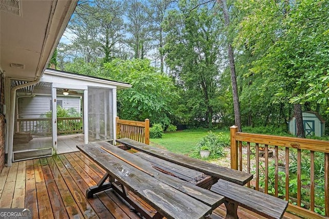 890 Oriole Ln, Marietta, GA 30067 - wooden deck with a sunroom, outdoor dining area, a storage shed, and an outdoor structure